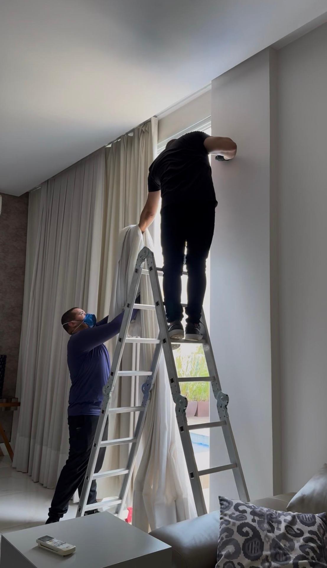Equipe reinstalando cortina após higienização